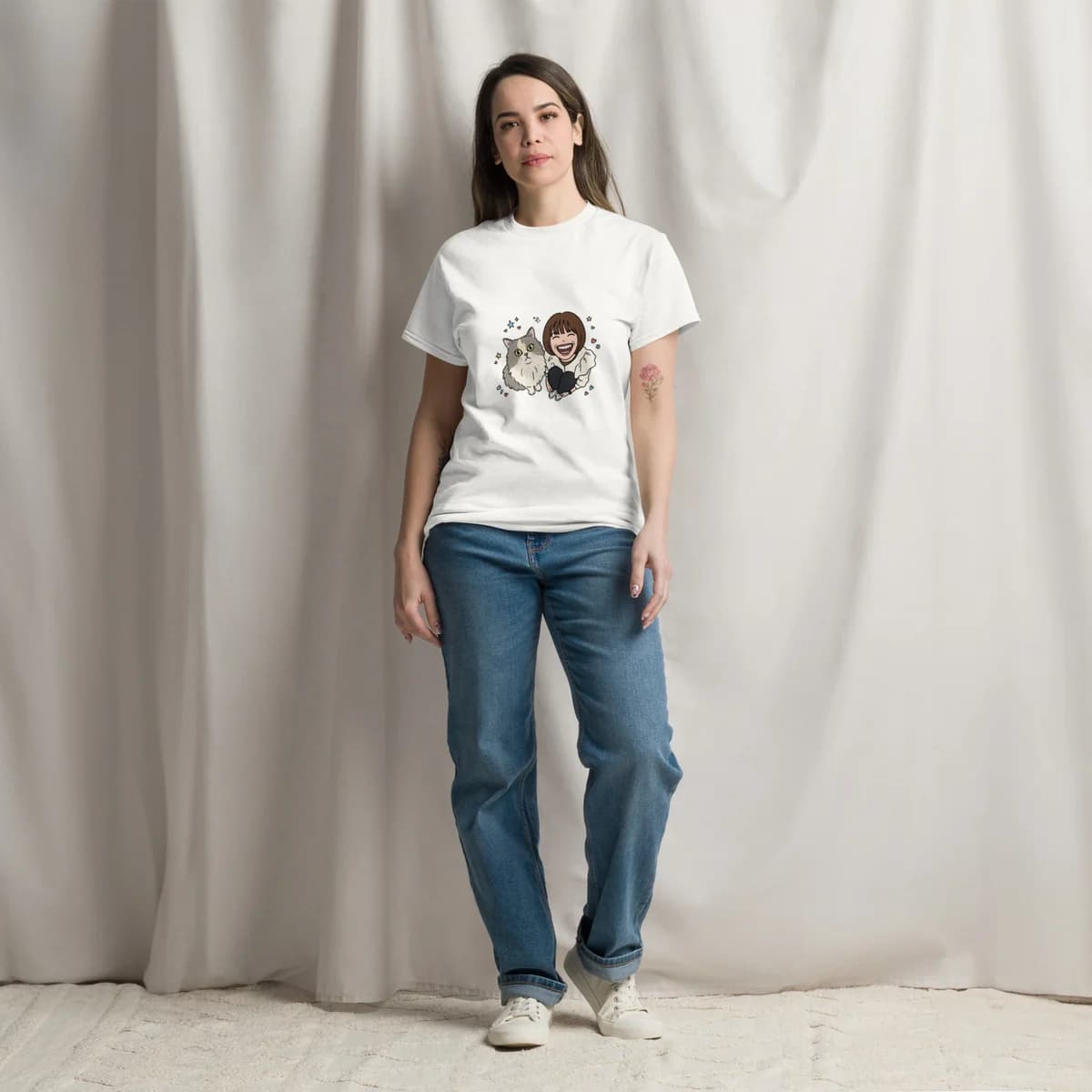 Model wearing the white classic tee with an illustrated portrait of a person and their cat across the chest